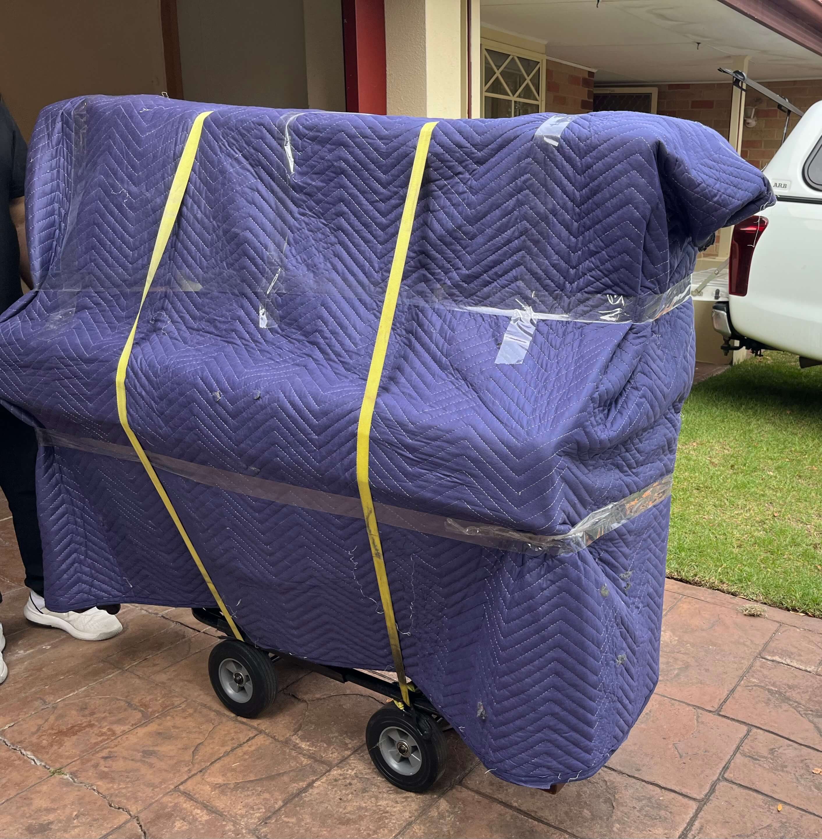 Imperial relocations team packing and moving piano